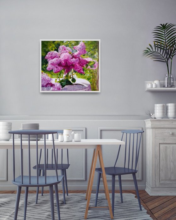 Lilac bouquet in a glass vase in the garden still life