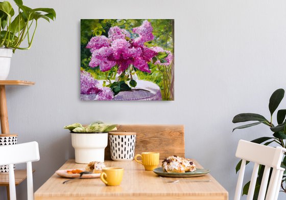 Lilac bouquet in a glass vase in the garden still life