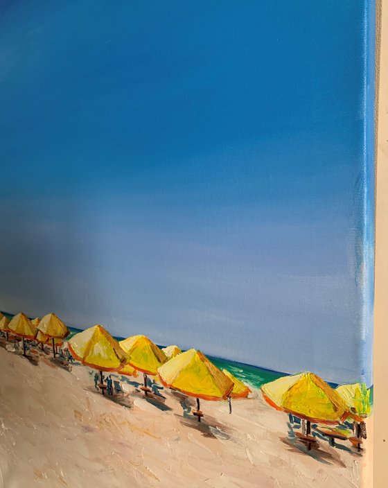 At the beach. Yellow parasols.