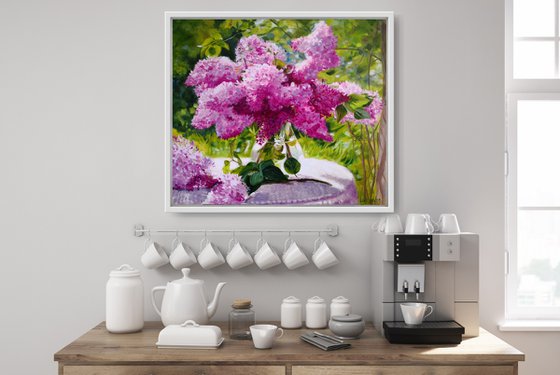 Lilac bouquet in a glass vase in the garden still life