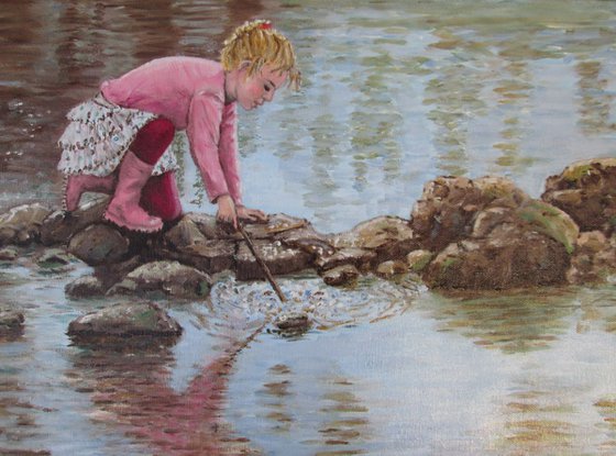 Girl playing by a lake