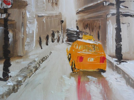 Winter city street with yellow taxi