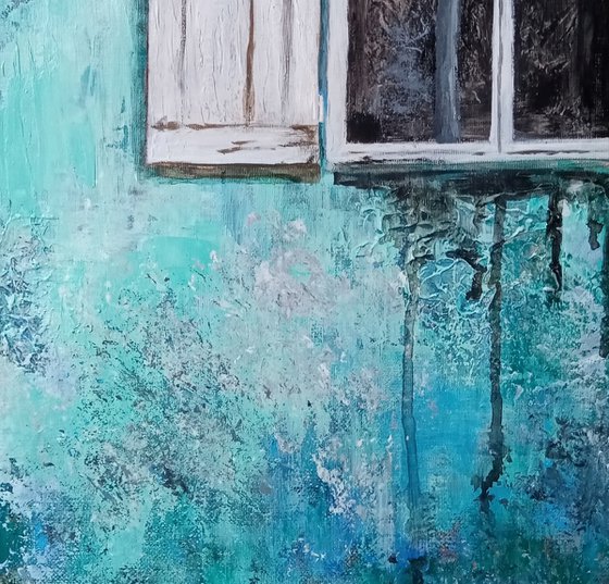 A window in a turquoise wall