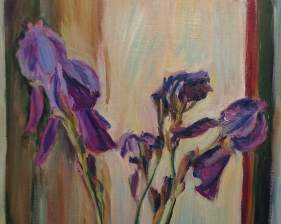 Purple irises in a long vase