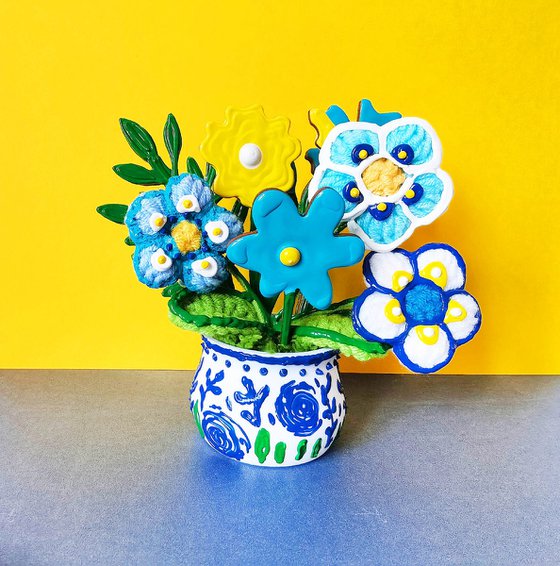 Blue crochet flowers in vase