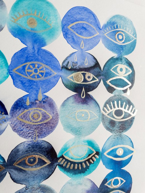 Gold leaf eyes on blue watercolor background