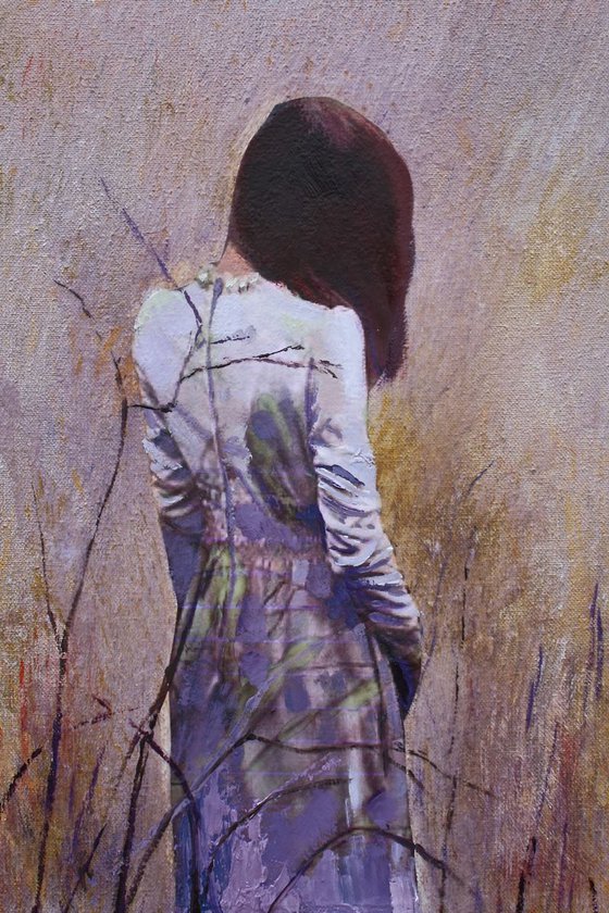Woman standing on the edge of a cornfield.