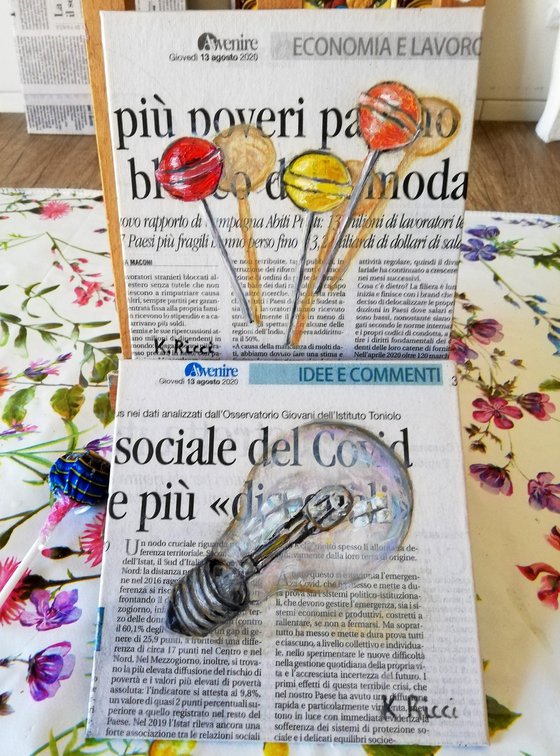 Light Bulb on Newspaper