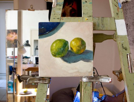 modern still life of green lemons