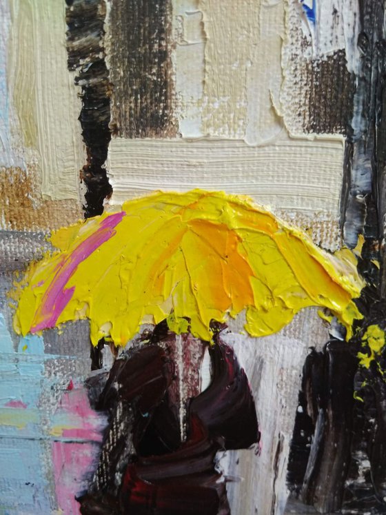 Rainy evening in the City and woman with yellow umbrella