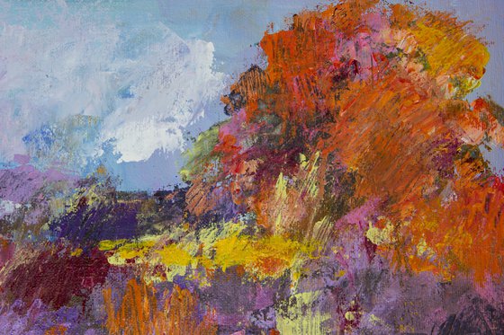 Landscape with wildflowers and a big red-orange tree