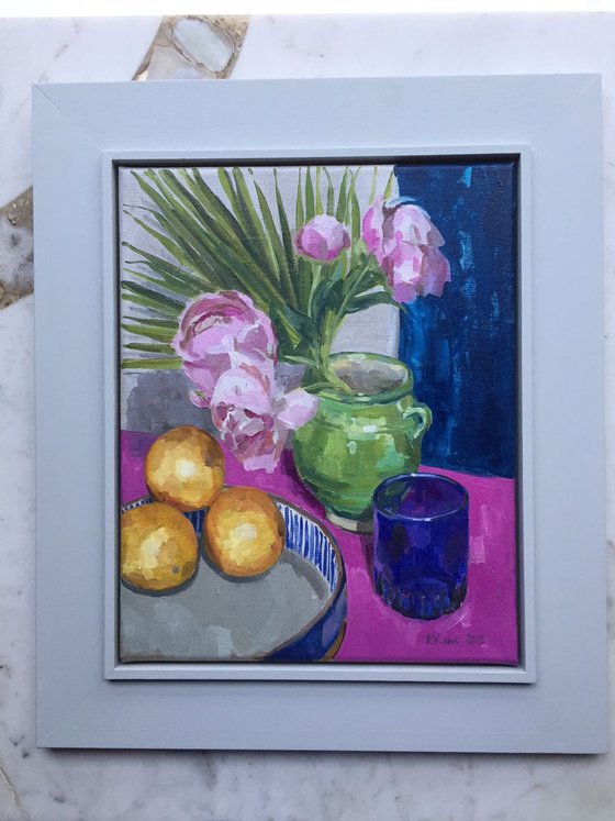Green vase with blue glass and oranges