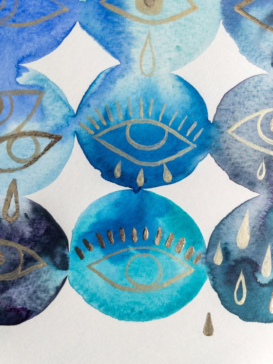 Gold leaf eyes on blue watercolor background