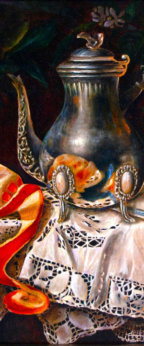Silver coffee pot with orange on a linen tablecloth by Inga Loginova