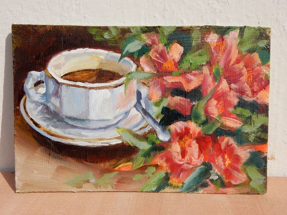 Tea cup with red flowers. Still life.
