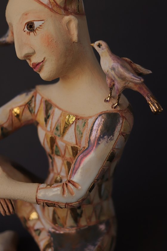 Harlequin with a golden bird.