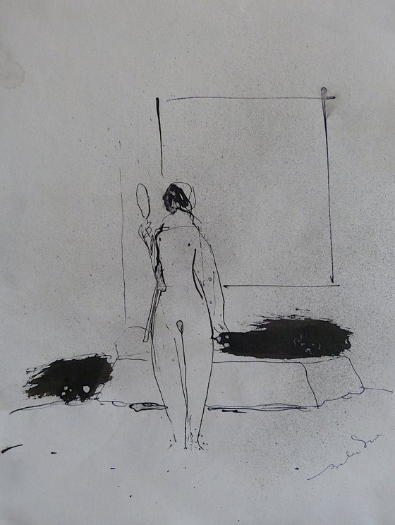 Nude looking in the mirror