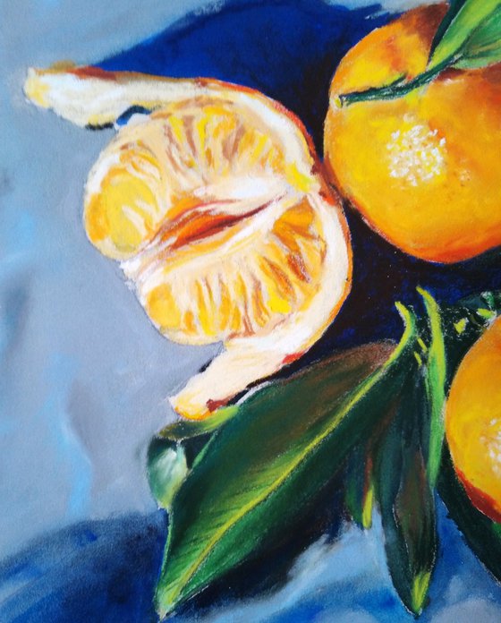 Three tangerines on blue