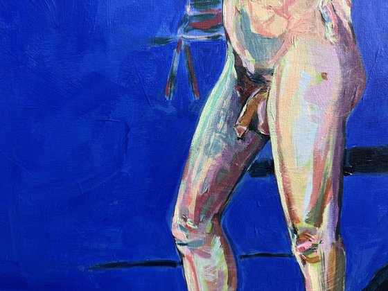 Young nude man in blue room