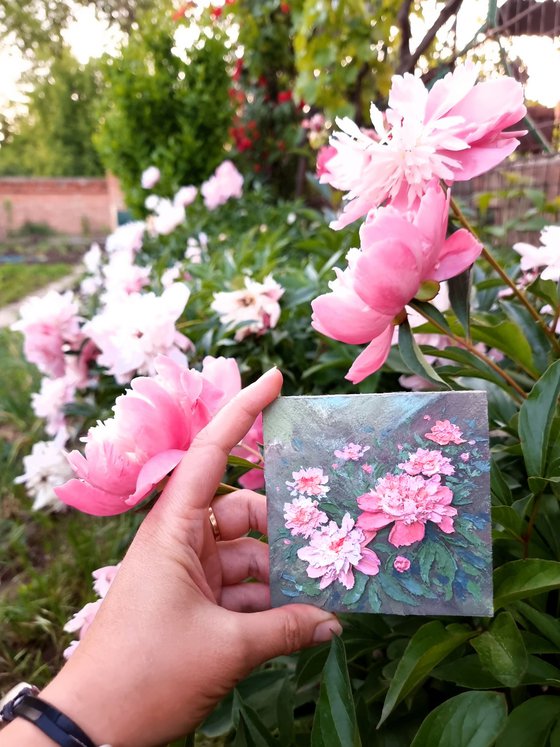 Miniature pink peonies. A small floral botanical relief. 3d painting of spring flowers with ceramic petals.