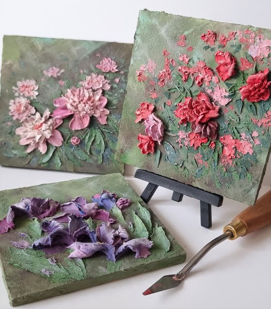 Miniature pink peonies. A small floral botanical relief. 3d painting of spring flowers with ceramic petals.