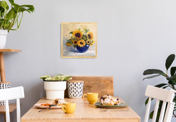 Sunflowers bouquet in a blue glass vase still life