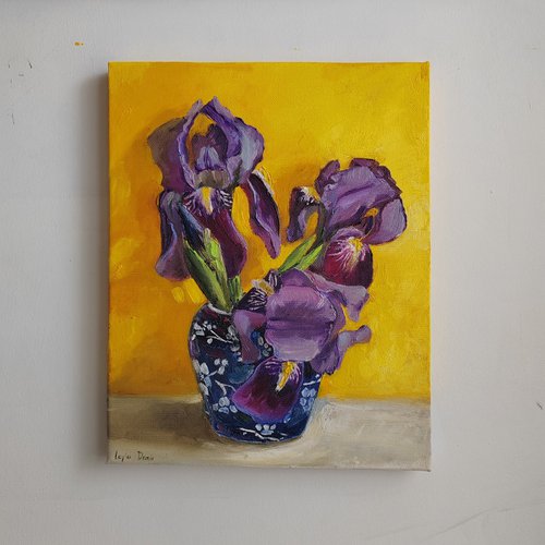 Purple iris bouquet on yellow background by Leyla Demir