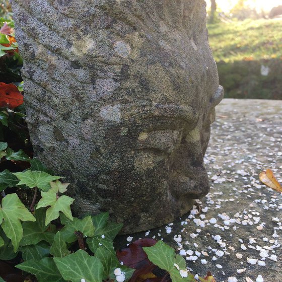 Stillness; face of a woman (weathered stone carving)