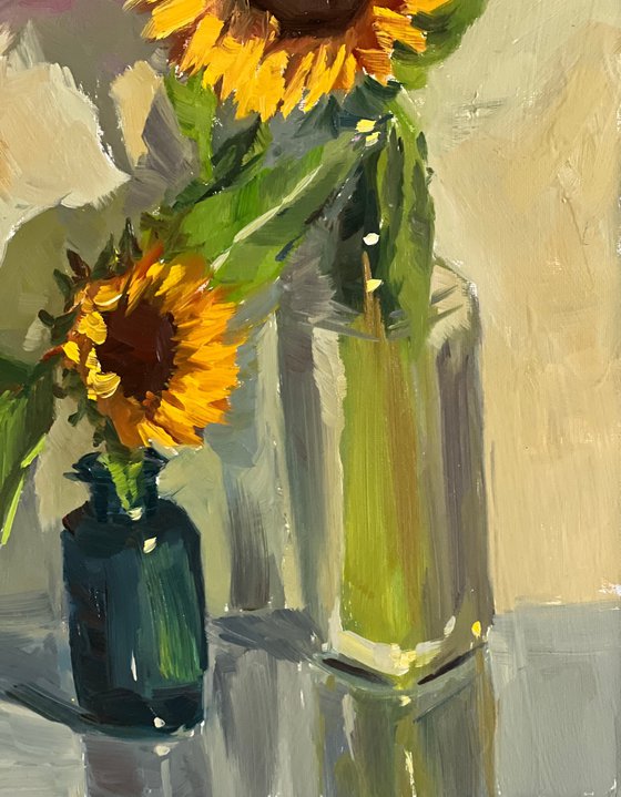 Sunflowers with a blue glass