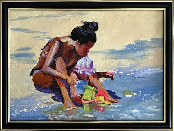 Mom with a kid on the beach.