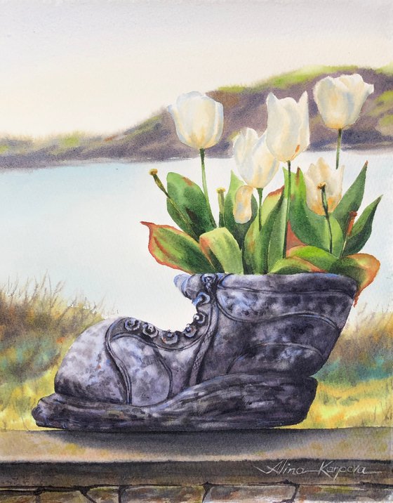 White tulips in old shoe planter sea view