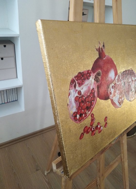 Pomegranate fruit on gold