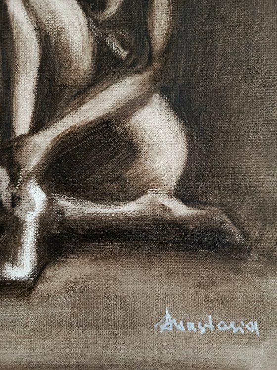 Nude woman sitting