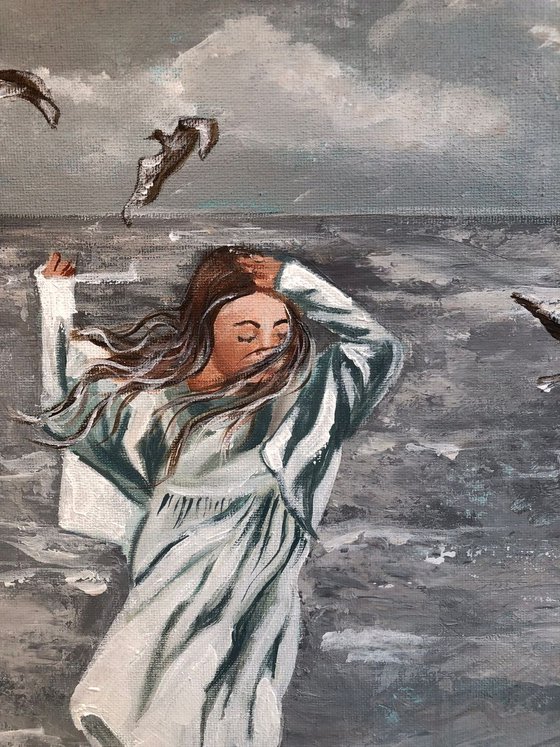 Girl and seagulls by the sea