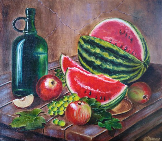 Watermelon and a flask of wine