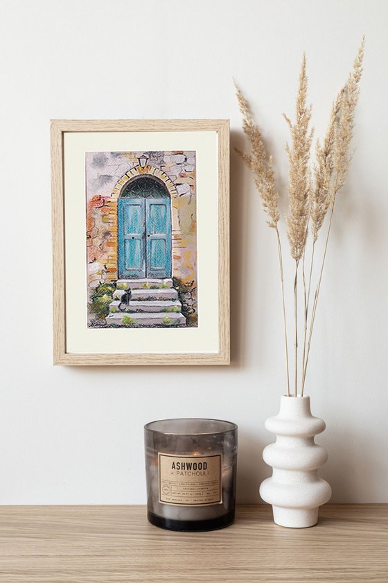 A cat at an old turquoise door