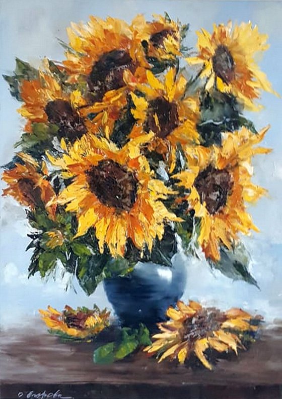 Sun flowers in blue vase