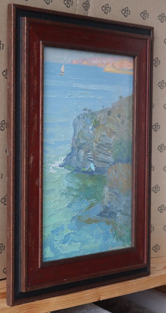 A lonely white sail gleams