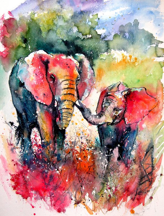 Colorful elephant with baby on the field
