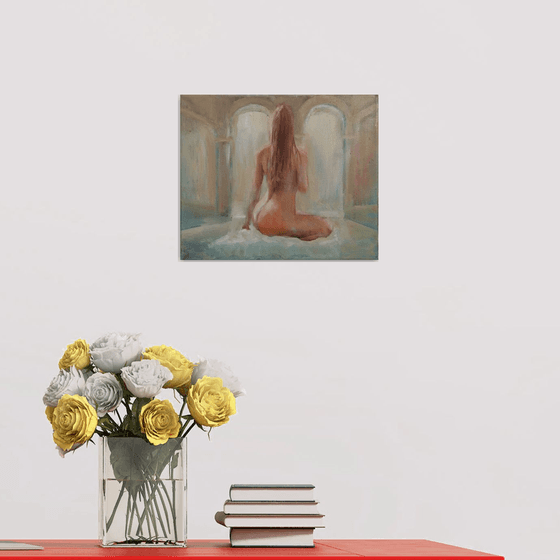 Nude woman seated by the pool