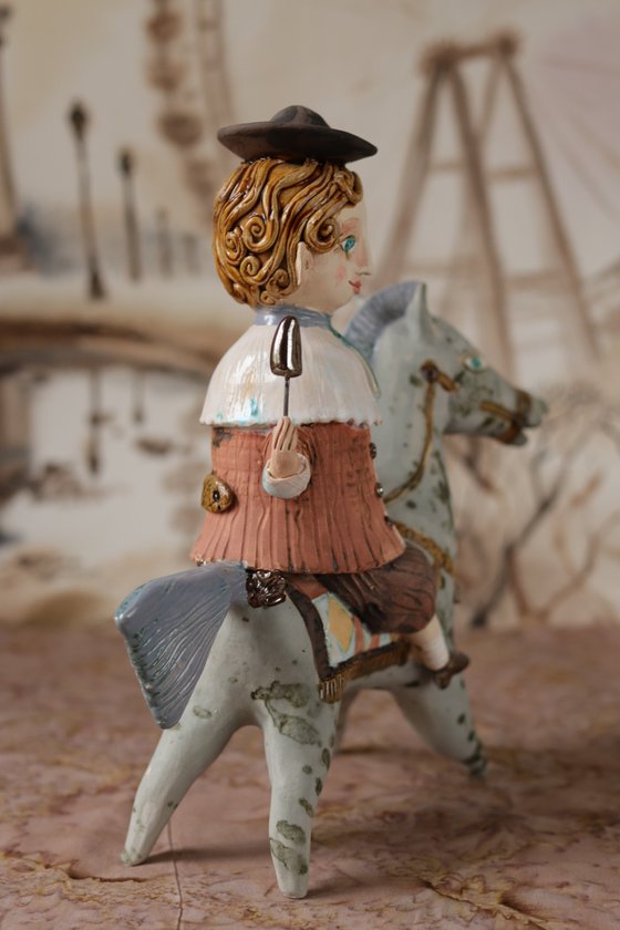 Vintage dressed boy riding a blue horse. From "Le Carousel, Hommage à l'Innocence" project by Elya Yalonetski