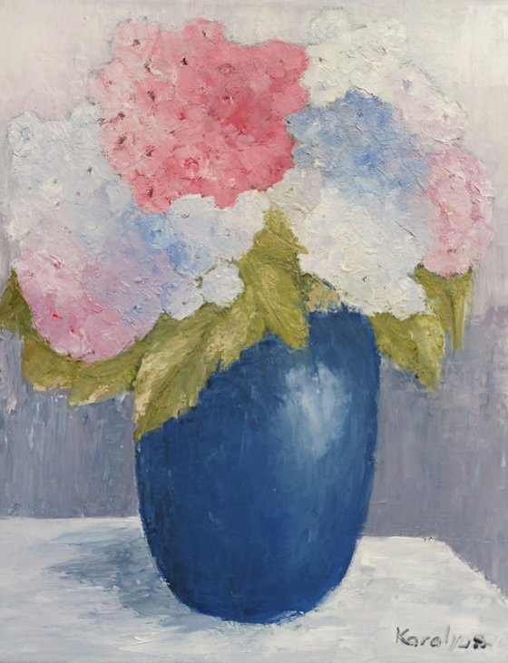 Blue vase with hydrangea flowers