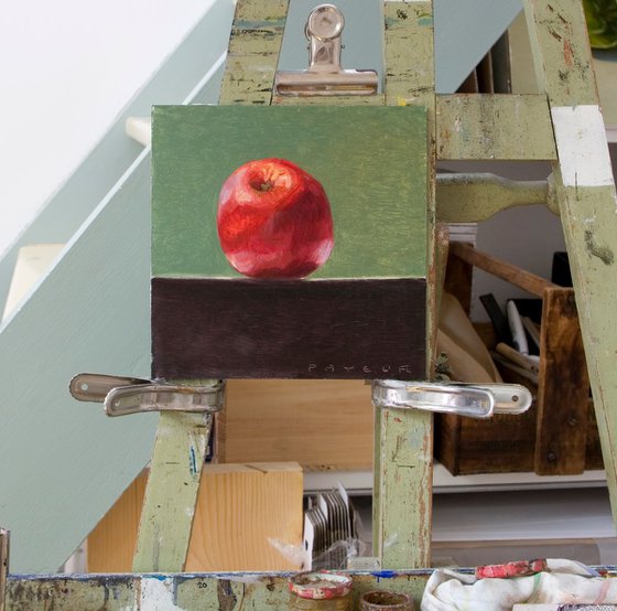 still life of fresh red apple on a green background