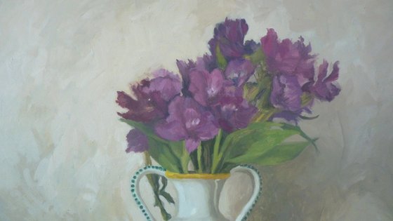 Purple flowers in a colorful jug