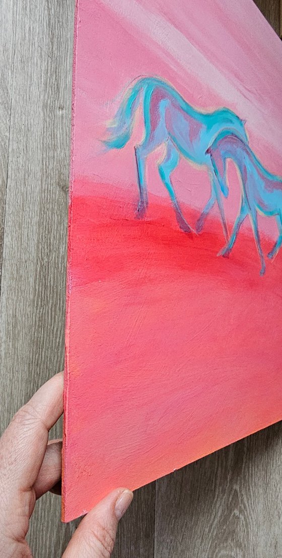 White blue horses at soft pink sunset