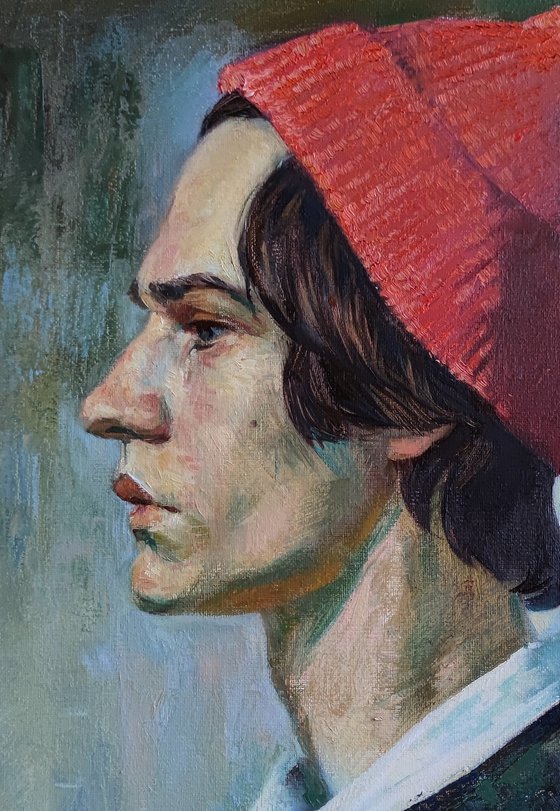 Portrait of a young man in a pink hat