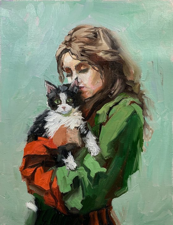 Girl in green dress with cat.