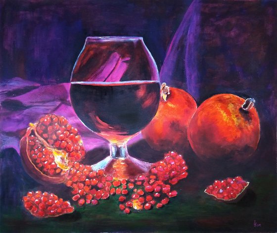 Ripe pomegranate and a glass of wine