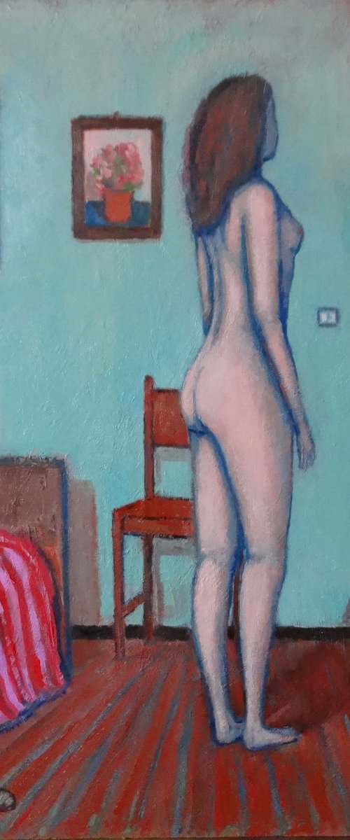 Woman standing in her room by Massimiliano Ligabue
