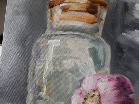 Glass jar and garlic. Still life.